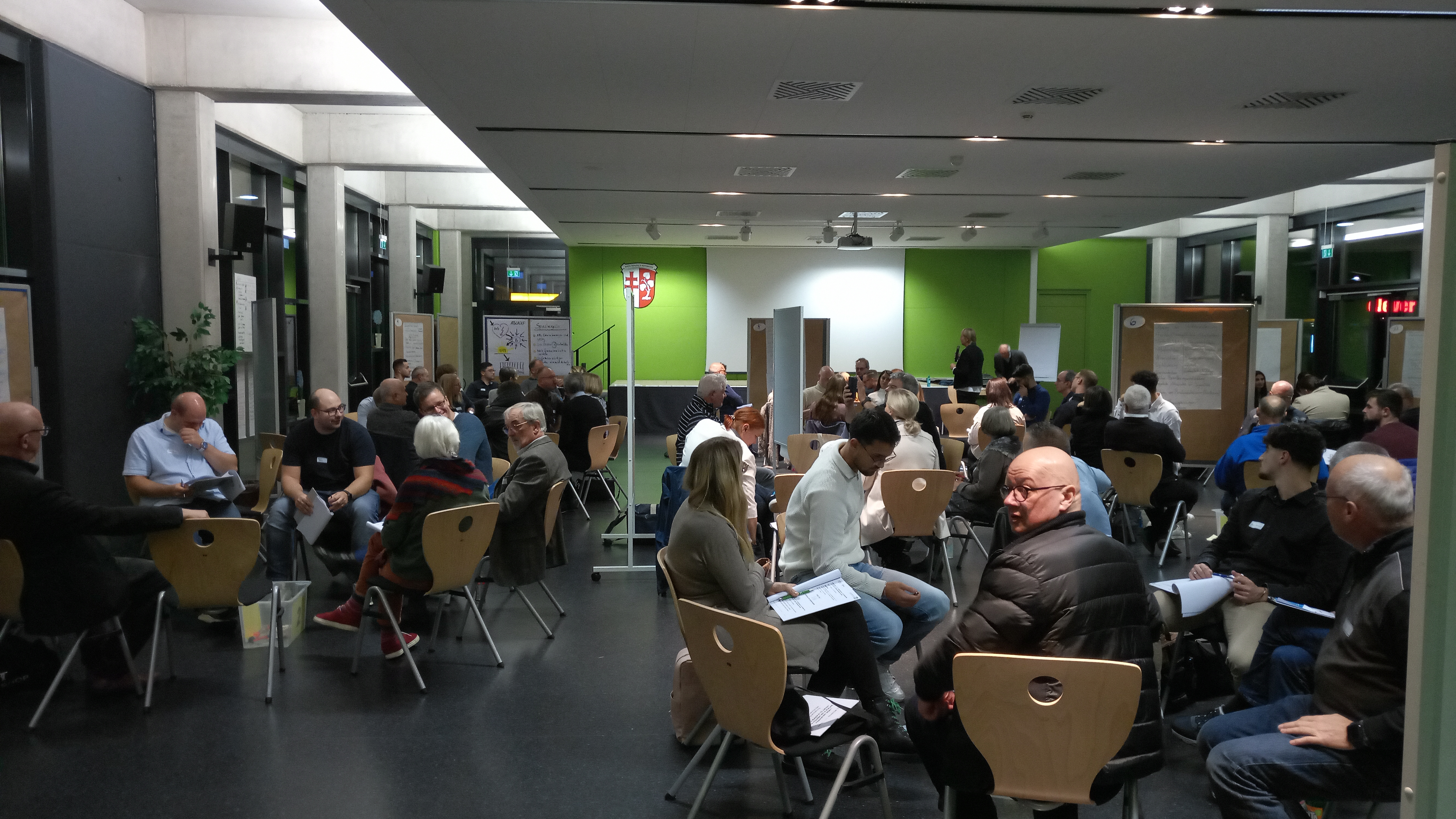 Zukunftskonferenz in Bebra Veranstaltungsraum, Teilnehmende siten in Stuhlkreisen und diskutieren
