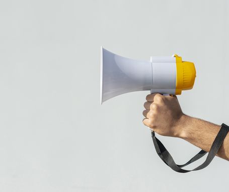 hand holding megaphone protest. High quality beautiful photo concept