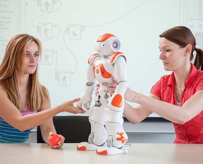 Gruppe Studierende mit Roboter