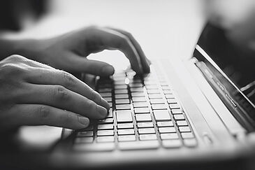 Male hands on a laptop keyboard