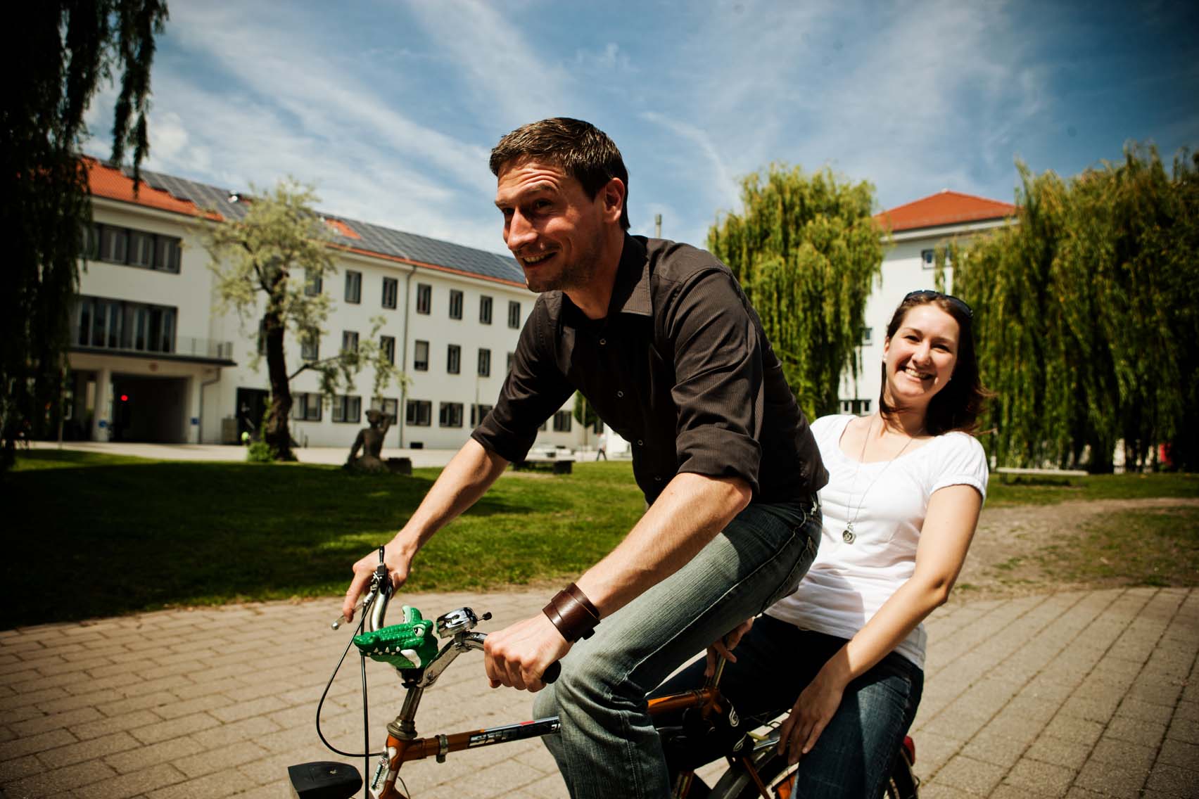 Gruppe Studierende fährt mit dem Rad auf dem Campus