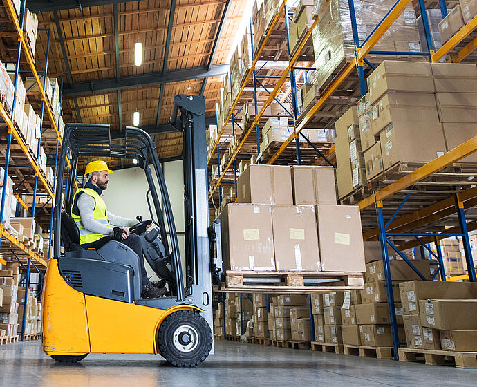 Warehouse man worker with forklift.