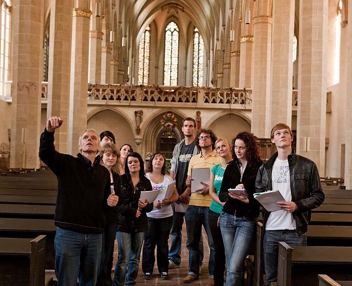 Eine Gruppe Studierende besucht die Predigerkirche in Erfurt
